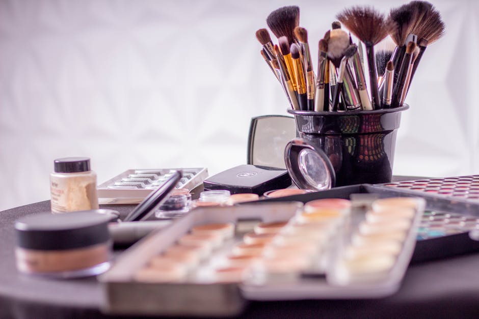 Close-up of a professional makeup brush set and cosmetics on a table for beauty use
